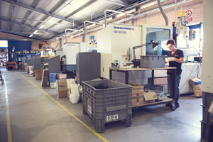 Thermoplastic moulding department where specialised operators work.